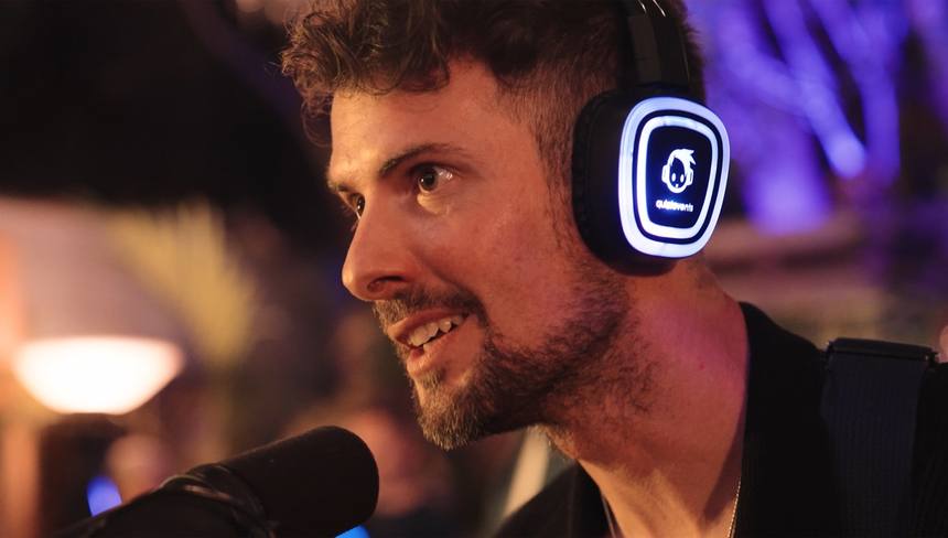 Close-up of a guest wearing glowing blue LED headphones